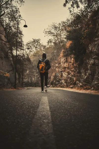 Man walking on road during daytime — Photo by Harsh Gupta on Unsplash