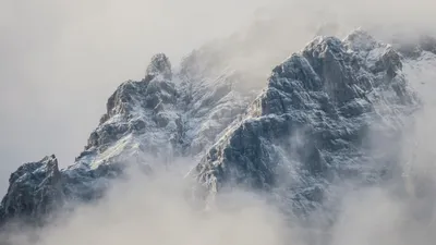 Mountain climber pushing through fog - Photo by Paul Pastourmatzis on Unsplash