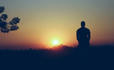 Person silhouetted at sunrise working alone - Photo by Arifur Rahman on Unsplash