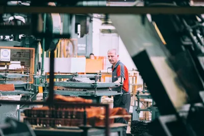 Factory worker repeating task with precision - Photo by Sam Moghadam on Unsplash