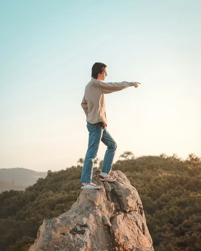 Person standing on rock showing leadership - Photo by Long Truong on Unsplash