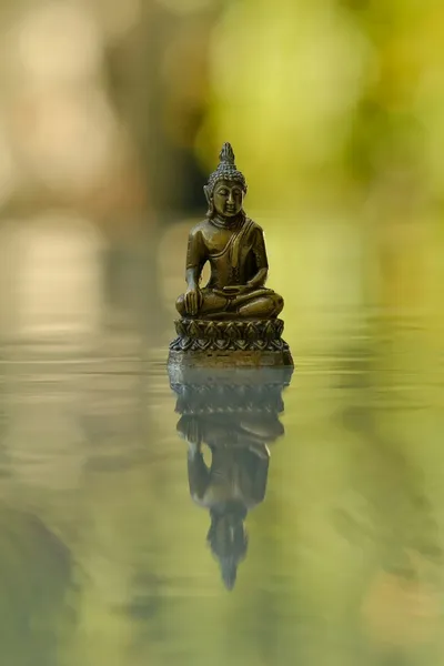 Buddha statue on water - Photo by József Szabó on Unsplash