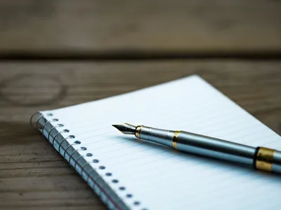 Pen on paper, writing down a plan — Photo by Aaron Burden on Unsplash
