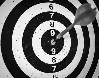 Target with arrow in center - Photo by Mauro Gigli on Unsplash