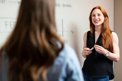 Woman engineer in discussion with colleague - Photo by ThisisEngineering on Unsplash