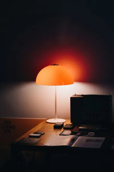 A writer working at a desk in dim light — Photo by Emilio Garcia on Unsplash