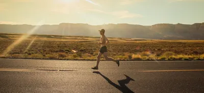 A runner on a track during golden hour — Photo by Isaac Wendland on Unsplash