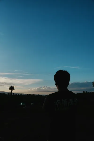 Person looking toward the horizon at sunrise — Photo by Carlo Sierra on Unsplash