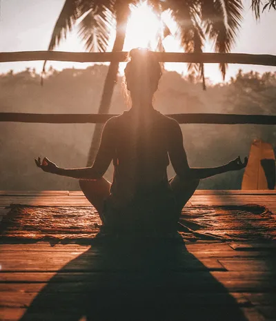 Person meditating in a serene Japanese temple garden