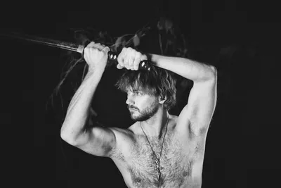 Man holding a sword with fierce determination